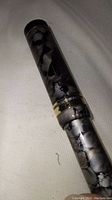 Close-up photo of the cap and barrel of the marbled black and gray pen.