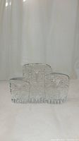 Front view of the three Kosta Boda clear glass owl figurines arranged in descending sizes