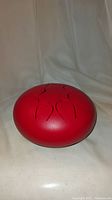 Front angled view highlighting the drum's rounded form and rubber feet base for stability.