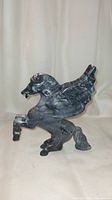 Front side view of the natural stone Pegasus statue showing detailed wings, head, and rearing pose