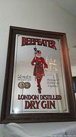 Full frontal view of the framed mirror showing the Beefeater guard image and advertising text.