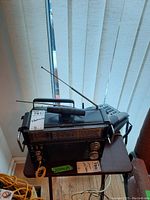 Venturer multiband receiver and radio cassette recorder together on small table with antennas extended and yellow coiled wire attached.