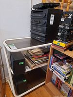 Photo of entire audio equipment setup including stacked Teac DC D888 Hi-Fi system components, two speakers on floor, and Digitron DVD player on top
