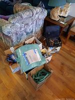 View of all items including boxes with tools, tarpaulin packaging, and rope