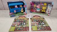 Photo of two boxed Peppa Pig toys and two assorted Melissa and Doug sticker packs arranged on a flat surface