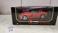 Front view of red Burago Dodge Viper RT/10 model car visible inside black and clear display box