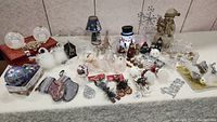 Wide shot of the full collection of assorted Christmas decorations including snowmen, baubles, and figurines
