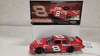 Photo of the red Budweiser Dale Earnhardt Jr die cast #8 car with its matching box behind.