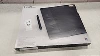 Photo of the Wacom Intuos5 Touch Professional Pen Tablet in its original box with included pen, the box is white and black with product image and branding, showing some wear.