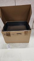 Front view of the box showing cart tray inside and cardboard box.