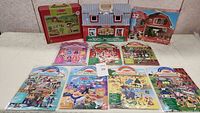 Full front view of all items included in the lot showing barn, puzzles, and sticker sets
