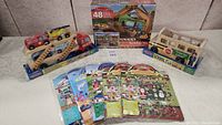 Full view of all toy items including car carrier, school bus, floor puzzle box, and sticker packs.
