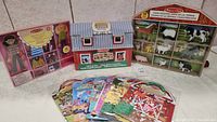 Full view of Melissa & Doug toys showing fold & go barn, farm animal figures, magnetic dolls box, and puffy sticker packs spread out.