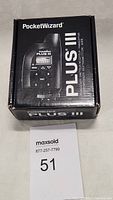 Box of PocketWizard Plus III radio transceiver with product image and branding.