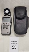 Front view of Sekonic L-358 meter with lumisphere and carrying case