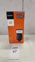 Box front showing Sony branding, product image of HVL-F58AM flash, and alpha camera logo.