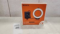 Sony HVL-RLAM ring light original orange box showing product image and key specs.
