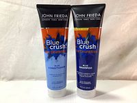 Both shampoo and conditioner tubes standing upright showing front labels and design