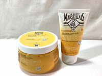Le Petit Marseilliais Nourishing Nutrition Body Balm and Hand Cream set in yellow and white packaging.