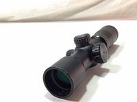 Side view of Excalibur Tact 100 scope showing objective lens and adjustment knobs