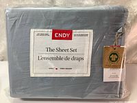 Front packaging label of ENDY king size bed sheet set showing 300 thread count, 100% organic cotton, in glacier blue color.