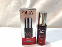 Photo of Olay Regenerist Miracle Boost Concentrate 30ml bottle next to its original product box, front view showing brand and product name.