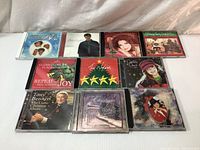 Front view of the 10 Christmas music CDs arranged in two rows showing album cover artwork and artist names