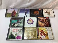 Full set of 10 Christmas and holiday music CDs displayed in jewel cases on a white surface.