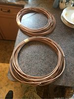 Two beige/tan rolls of coaxial cable coiled on a kitchen counter, showing general condition and size.