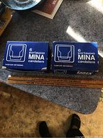 Two blue boxes each labeled ‘6 porta uovo Mina candelier’ showing the total 12 units of candleholders in the lot.