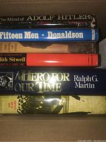Books stacked showing titles including The Mind of Adolf Hitler, Fifteen Men, Taken Care Of, A Hero for Our Time, and Six War Years
