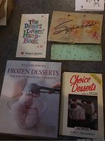 Photo shows front covers of four cookbooks: The Dessert Lovers Handbook, Squares, Williams Sonoma Frozen Desserts, and Choice Desserts.