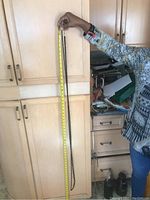 Photo showing one person holding two necklaces of significantly different lengths alongside a measuring tape for scale.