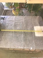 Large sheer off-white vintage scarf laid flat on a surface with measuring tape showing approximately 40 inches in length.