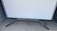 Lower half of whiteboard on stand showing control panel and caster wheels