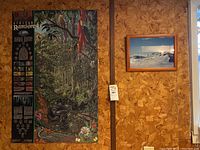 Large Rainforest poster with educational details and depiction of rainforest flora and fauna, hung on wood paneled wall