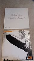 Front covers of the Rolling Stones 'Beggars Banquet' and Led Zeppelin albums showing their distinctive artwork.