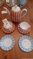 Top-down view of Winterling Bavarian teapot and teacups with matching saucers on wooden table