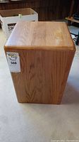 Front view of the solid wood cube showing wood grain and smooth finish