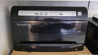 Front view of the FoodSaver vacuum sealer showing the main unit with control panel.