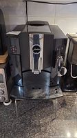 Front view of machine on countertop showing control panel, dual spout, drip tray