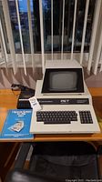 Front view of Commodore PET 2001 Series console with built-in monitor, keyboard, numeric keypad, black Datasette drive and BASIC manual