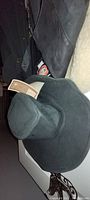 Black wide-brimmed outback hat with original tags.
