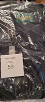 Front interior label showing Danier brand and men's medium size inside black leather vest