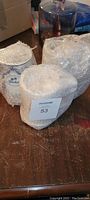 Three Franklin Mint beer tankards partially wrapped in bubble wrap on a wooden surface.