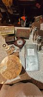 Image showing vintage pewter box, older tin tea and coffee tins, leatherette storage box, assorted wooden boxes, decorative plate, and vintage pins.