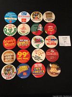 Top view photo showing all 20 McDonald's pins laid out on blue fabric.