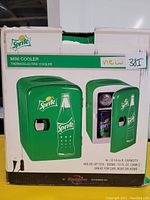 Box showing green Sprite branded mini cooler with a bottle graphic, front opening door; thermoelectric cooler with 4L capacity holding six 355ml cans.