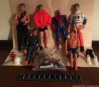 Full view of six action figures including Spider-Man, five male figures in various attire, and several accessories including boots, helmets, and rifles.