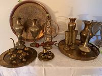 Showing full assortment of vintage etched brass pieces including vases, trays, cups and decorative items